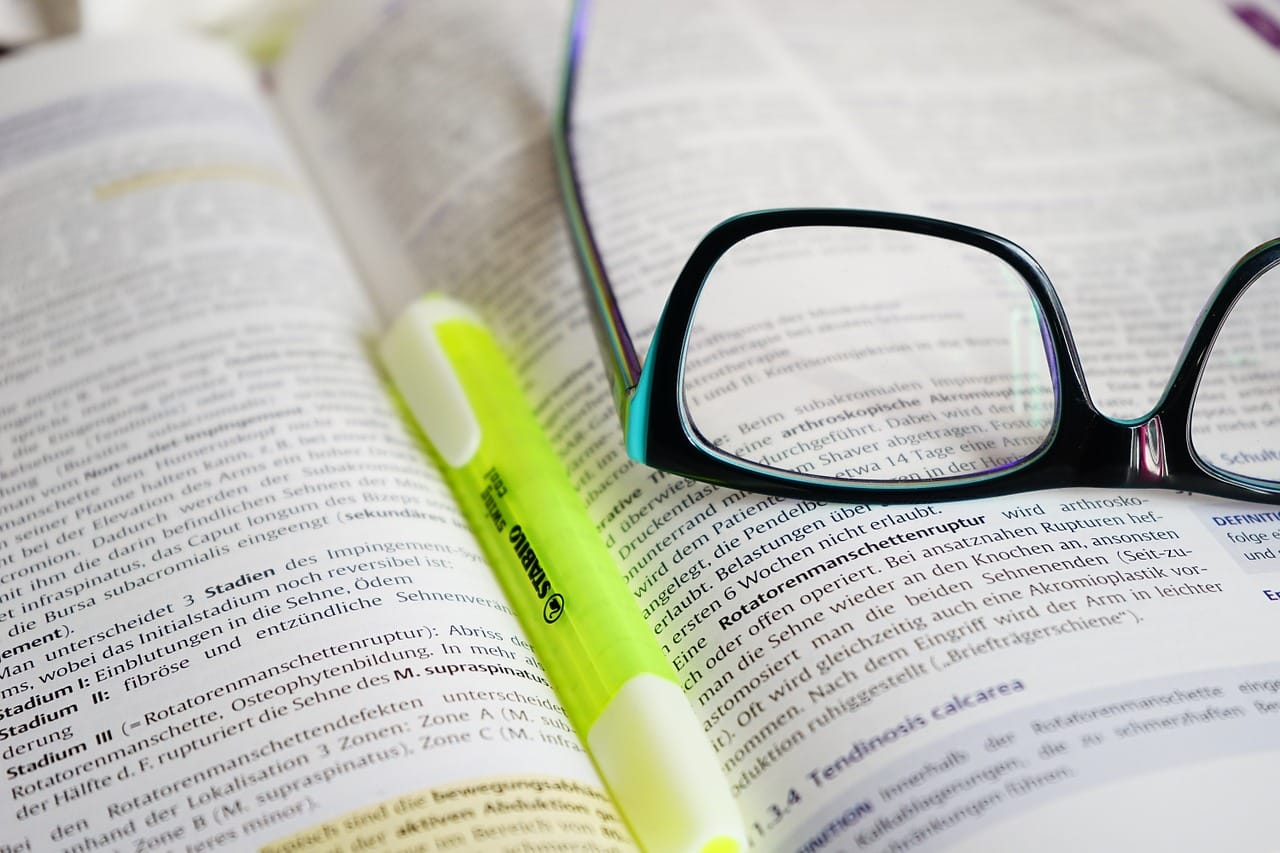 Open book with eye glasses