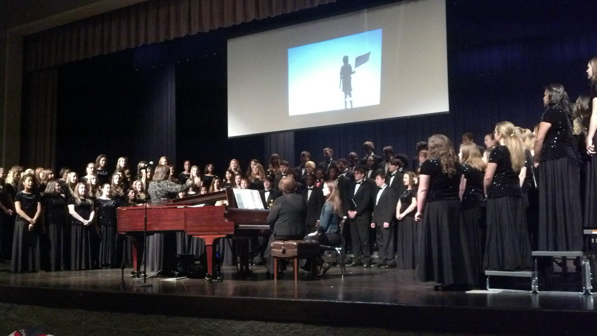 Choir with Veteran's Day photo in background