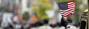 Veteran waving a small american flag