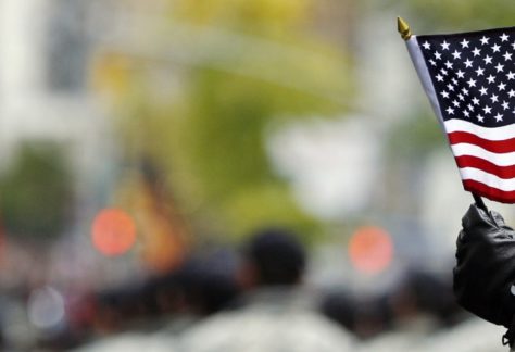 Veteran waving a small american flag
