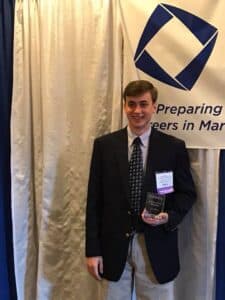 Dillon Boatwright holding award plaque