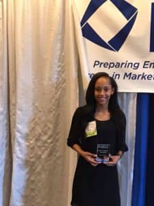 Jaliyah Byers holding award plaque