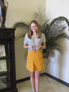 Mae Stacey holding award plaque