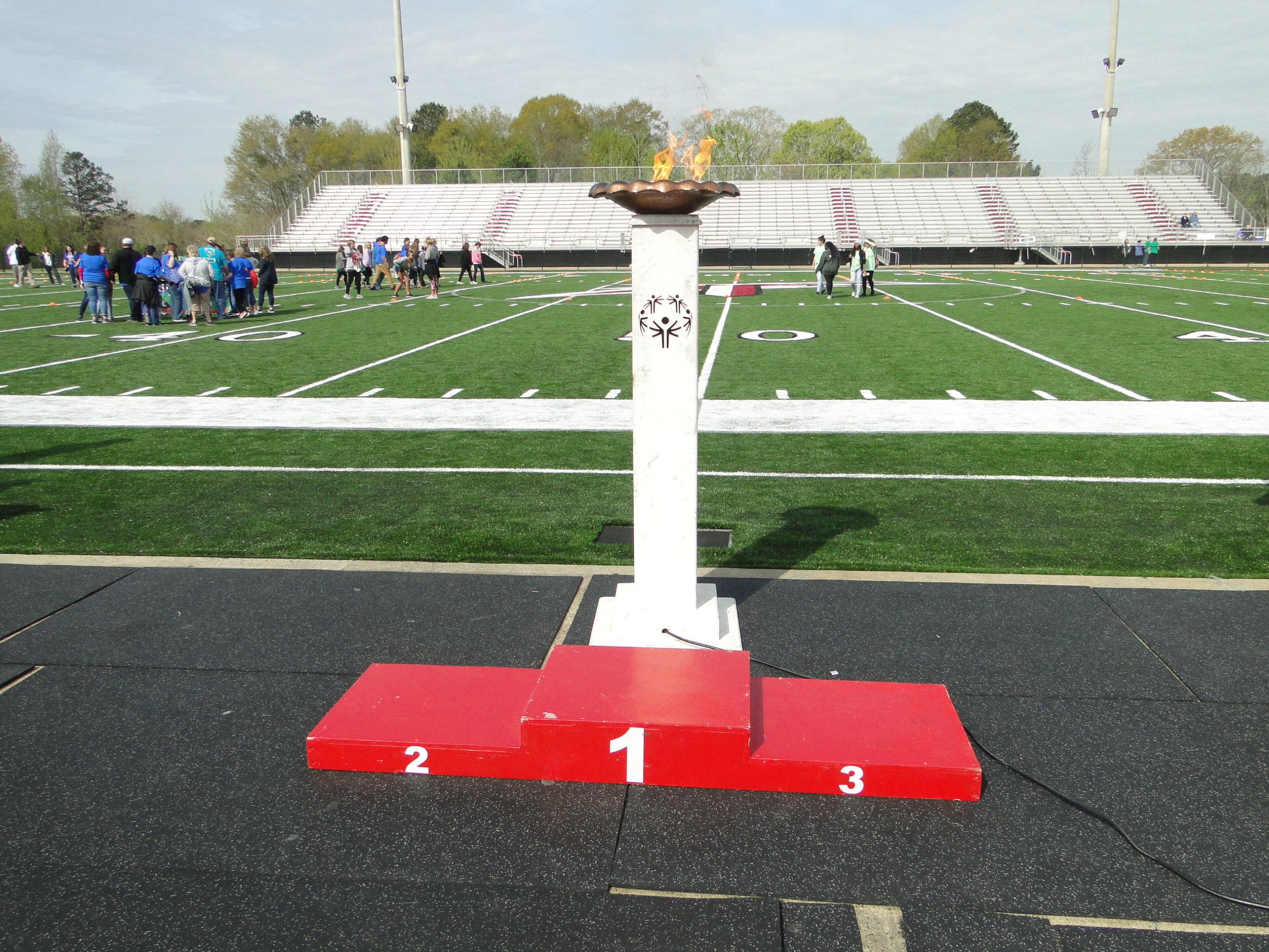 Winners podium with the olympic flame