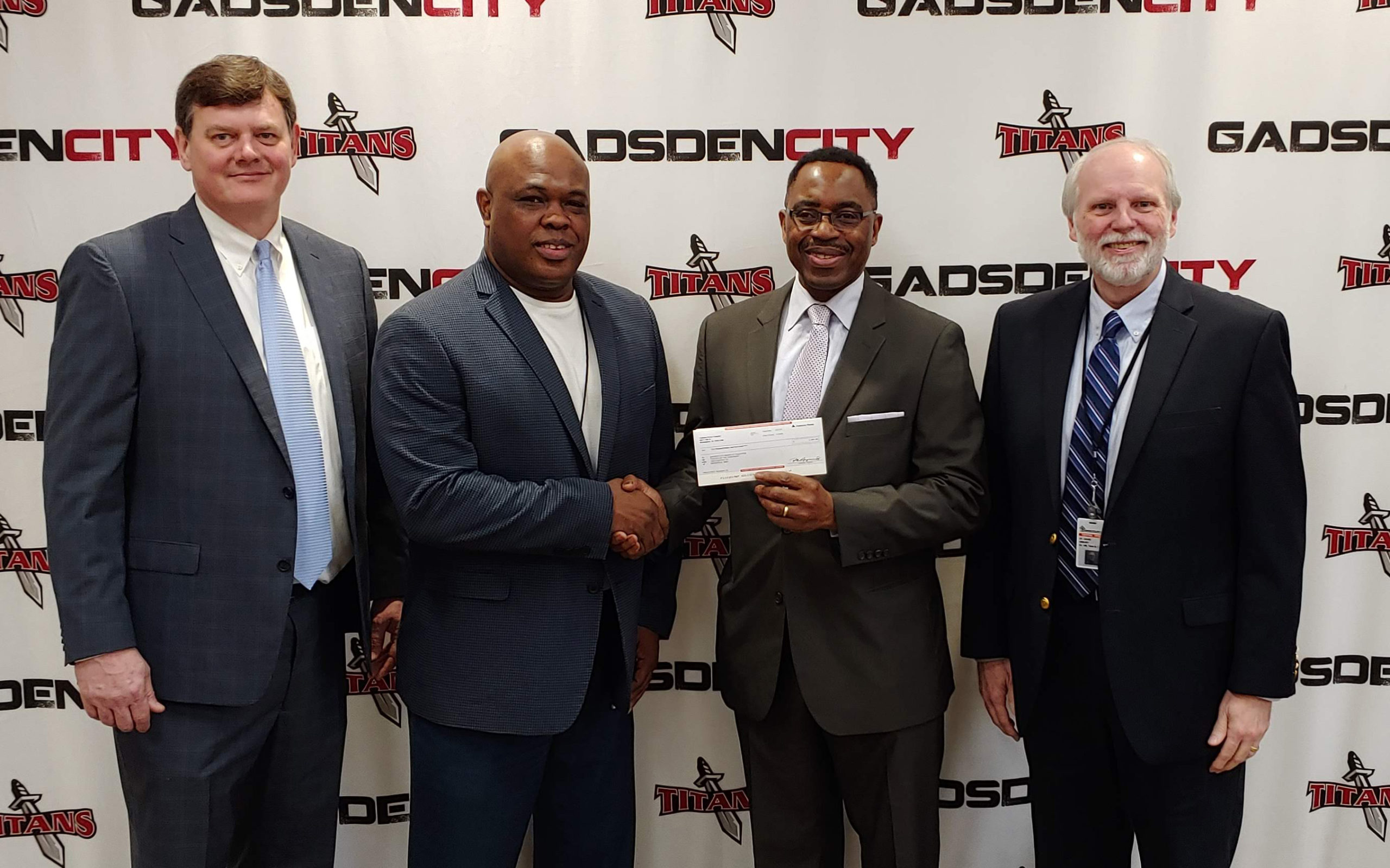 4 people with check being handed over