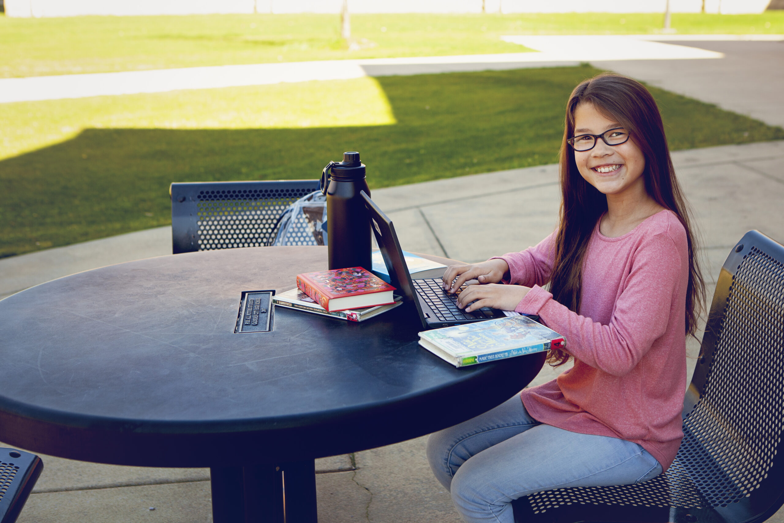 Outdoor Student at Table working on Laptop